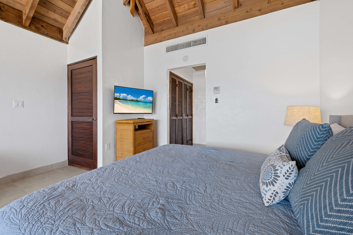 A spacious primary suite offering the perfect place to unwind after a day in paradise.