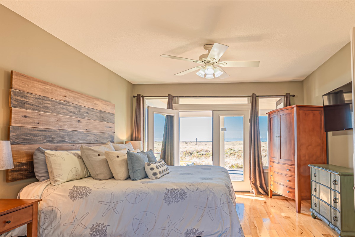 2nd bedroom on main floor has French doors on east & west sides of bedroom, both leading out to private deck space.