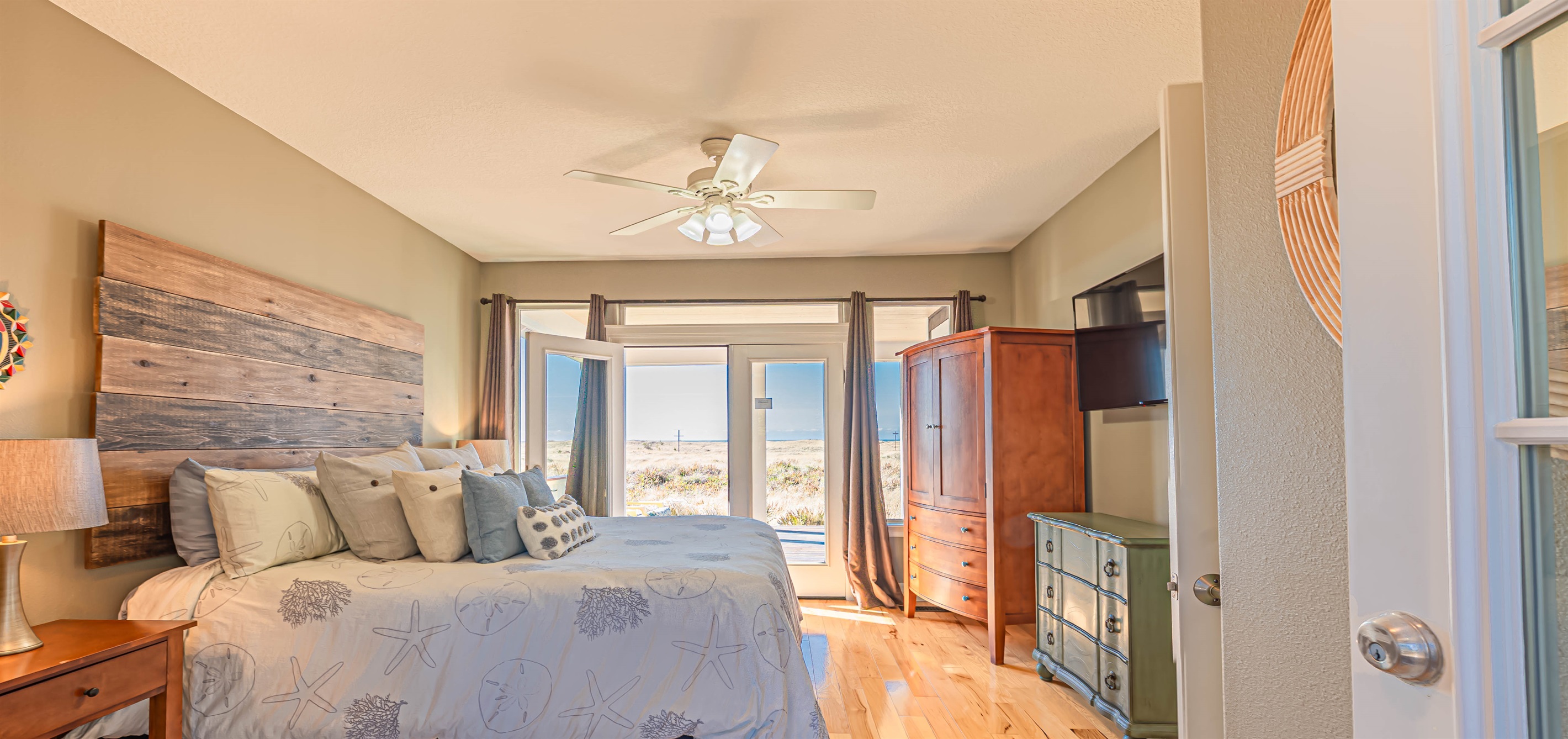 2nd bedroom on main floor has French doors on east & west sides of bedroom, both leading out to private deck space.
