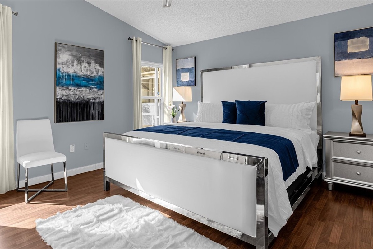 Spacious KING Master Bedroom with clean, white linens, luxury pillow top mattress, plenty of pillows, overlooking the pool