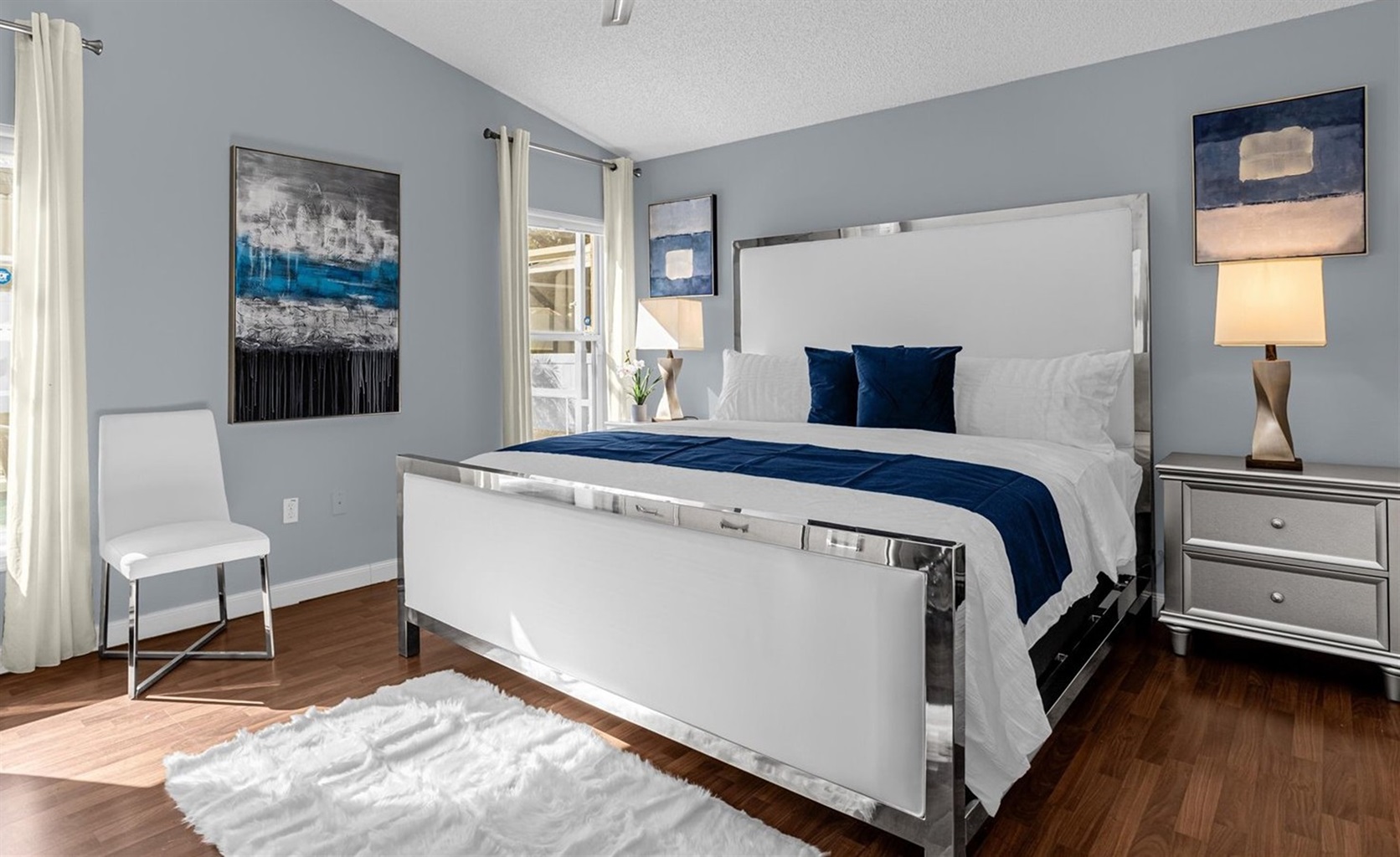 Spacious KING Master Bedroom with clean, white linens, luxury pillow top mattress, plenty of pillows, overlooking the pool