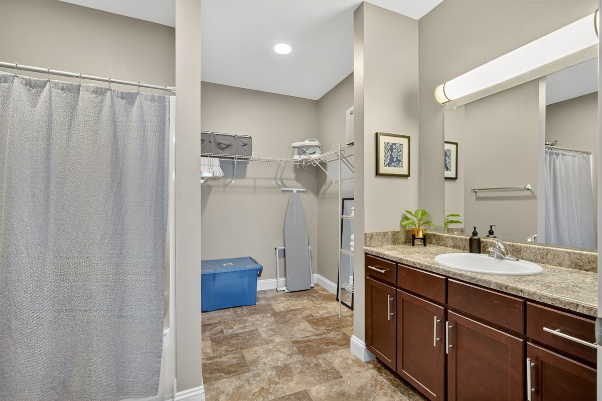 The primary bathroom features an expansive closet, vanity with tons of storage, tub/shower as well as provided linens, bathroom products and more.