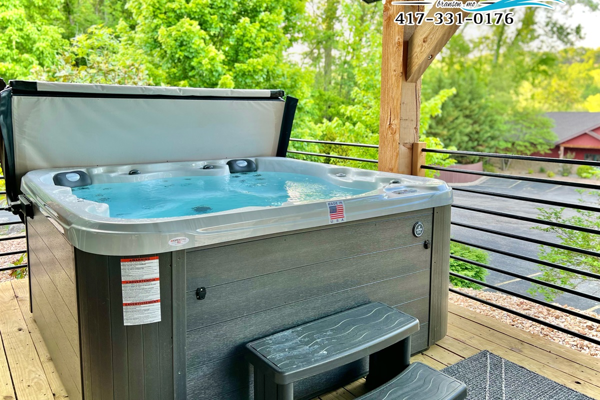 Relax in the warm hot tub and surrounded by lush greenery