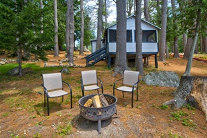private outdoor living with chairs and firepit.