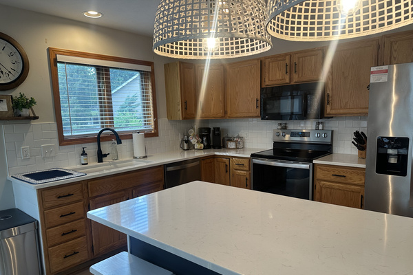 Fully stocked kitchen with island seating for 4.