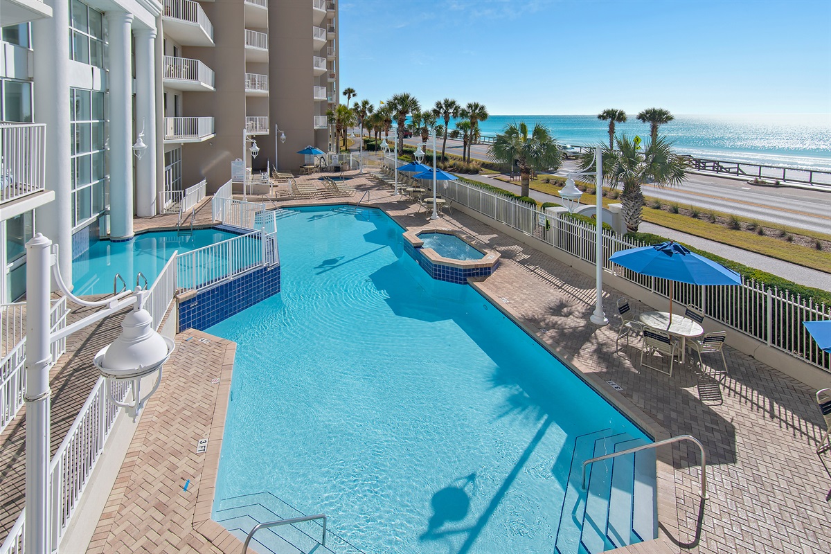 Resort style pool with plenty of seating, shade, and Gulf views!