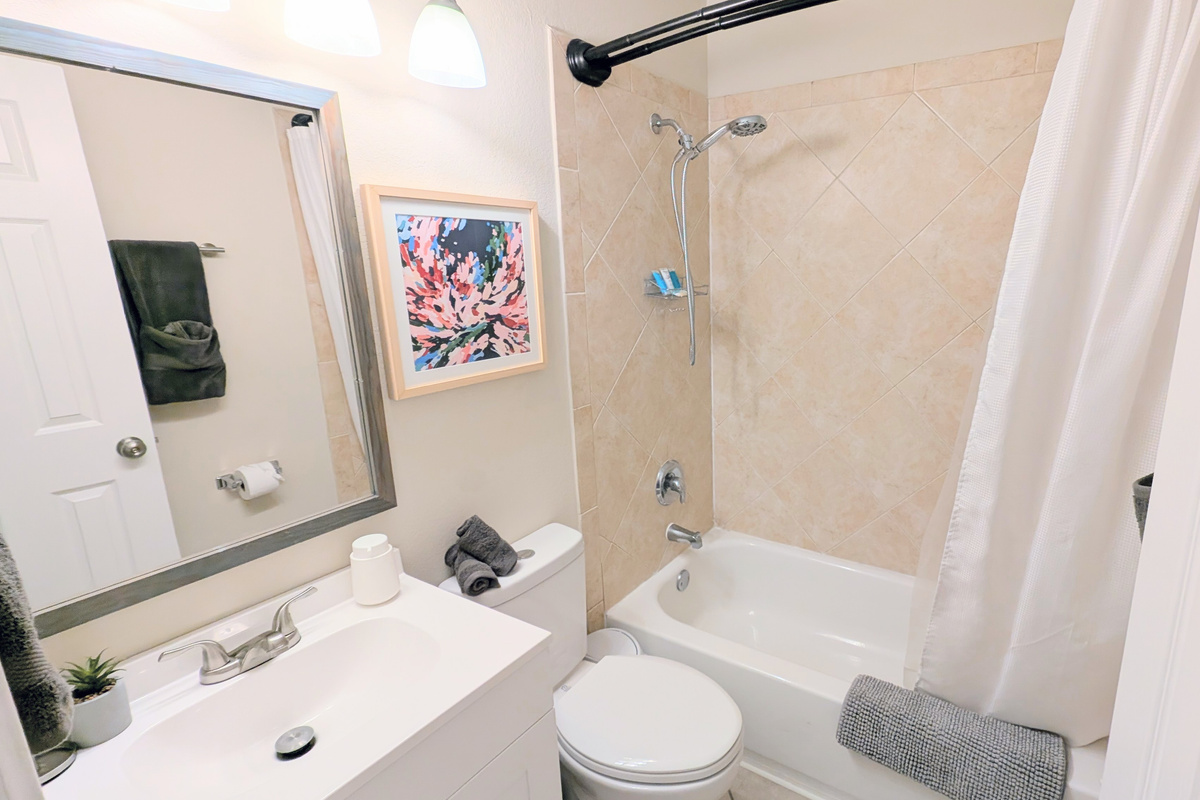 Full bathroom with tub/shower combo, water efficient toilet, fluffy towels, and fully stocked with toiletries and basic amenities. 