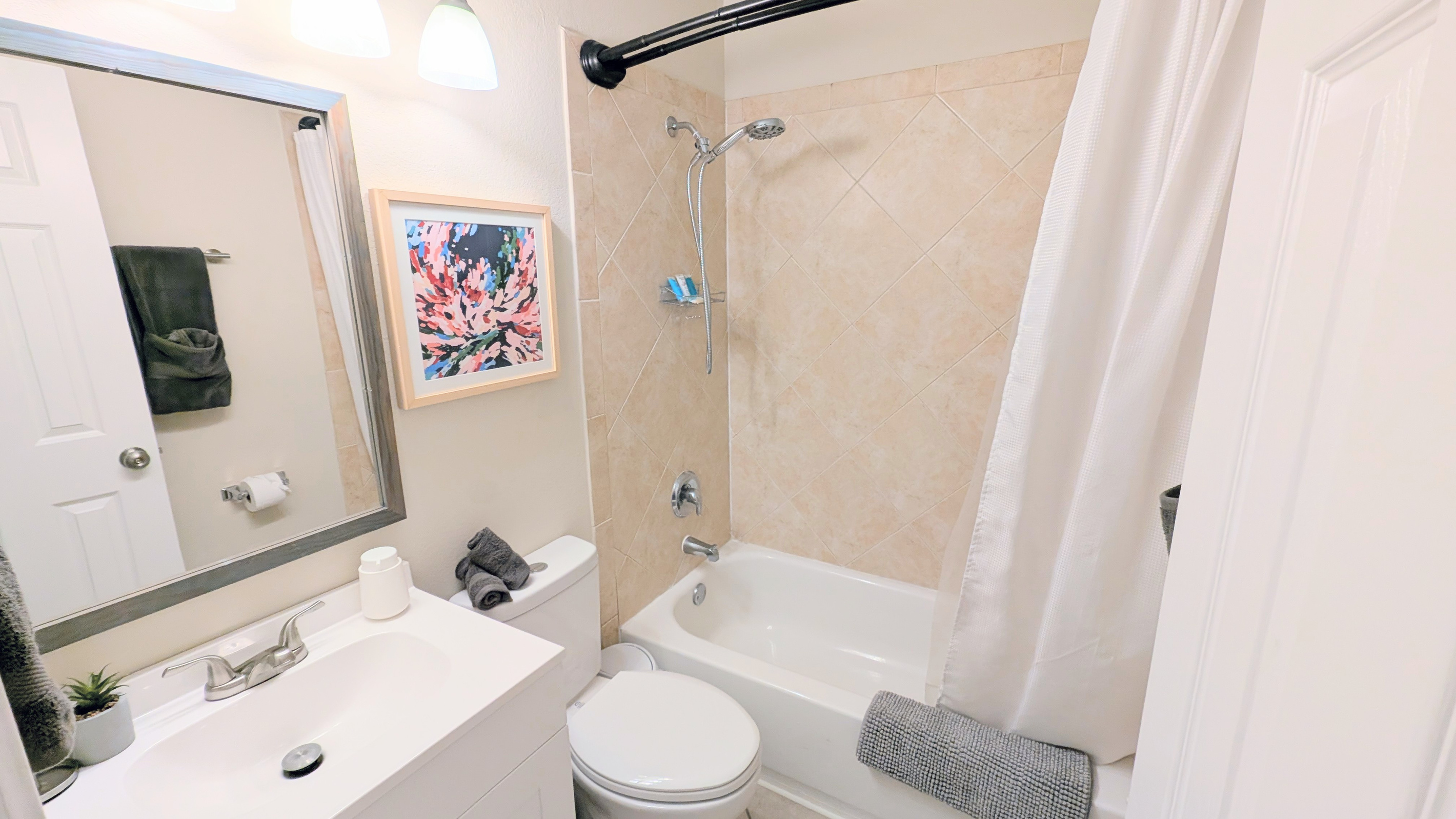 Full bathroom with tub/shower combo, water efficient toilet, fluffy towels, and fully stocked with toiletries and basic amenities. 