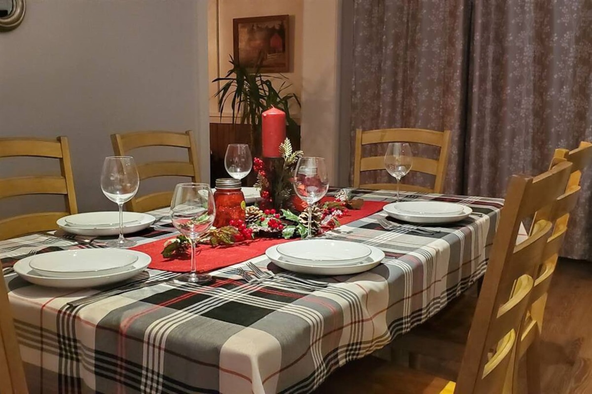 Festive Dining room table with seating just off kitchen area