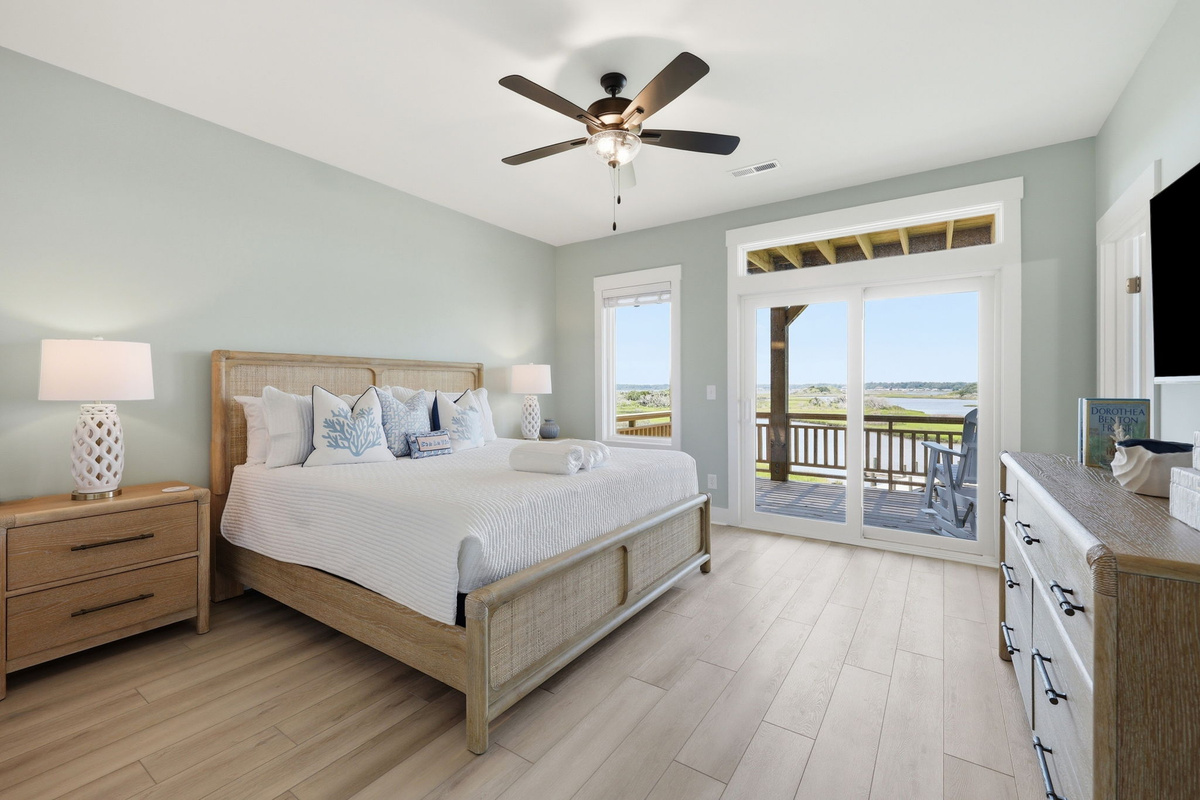 Wake up to peaceful water views in the king master bedroom with private balcony access