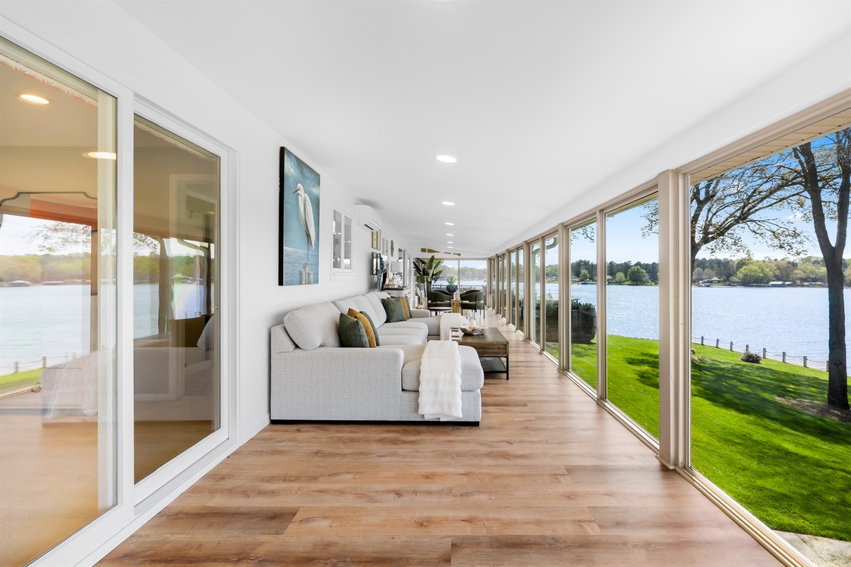 Unwind in the enclosed sunroom with panoramic water views. 