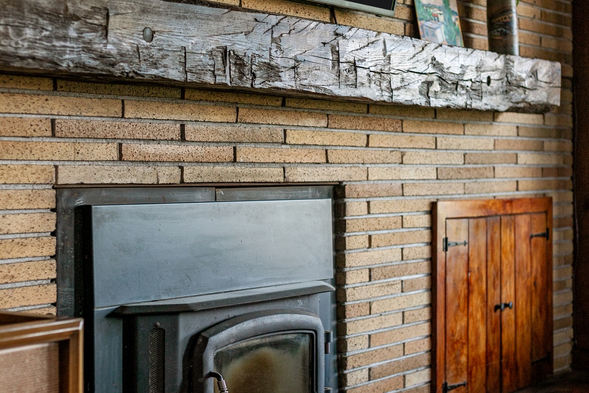 Cozy up by the wood-burning fireplace, the perfect spot to gather, unwind, and enjoy the warm glow on cool evenings.