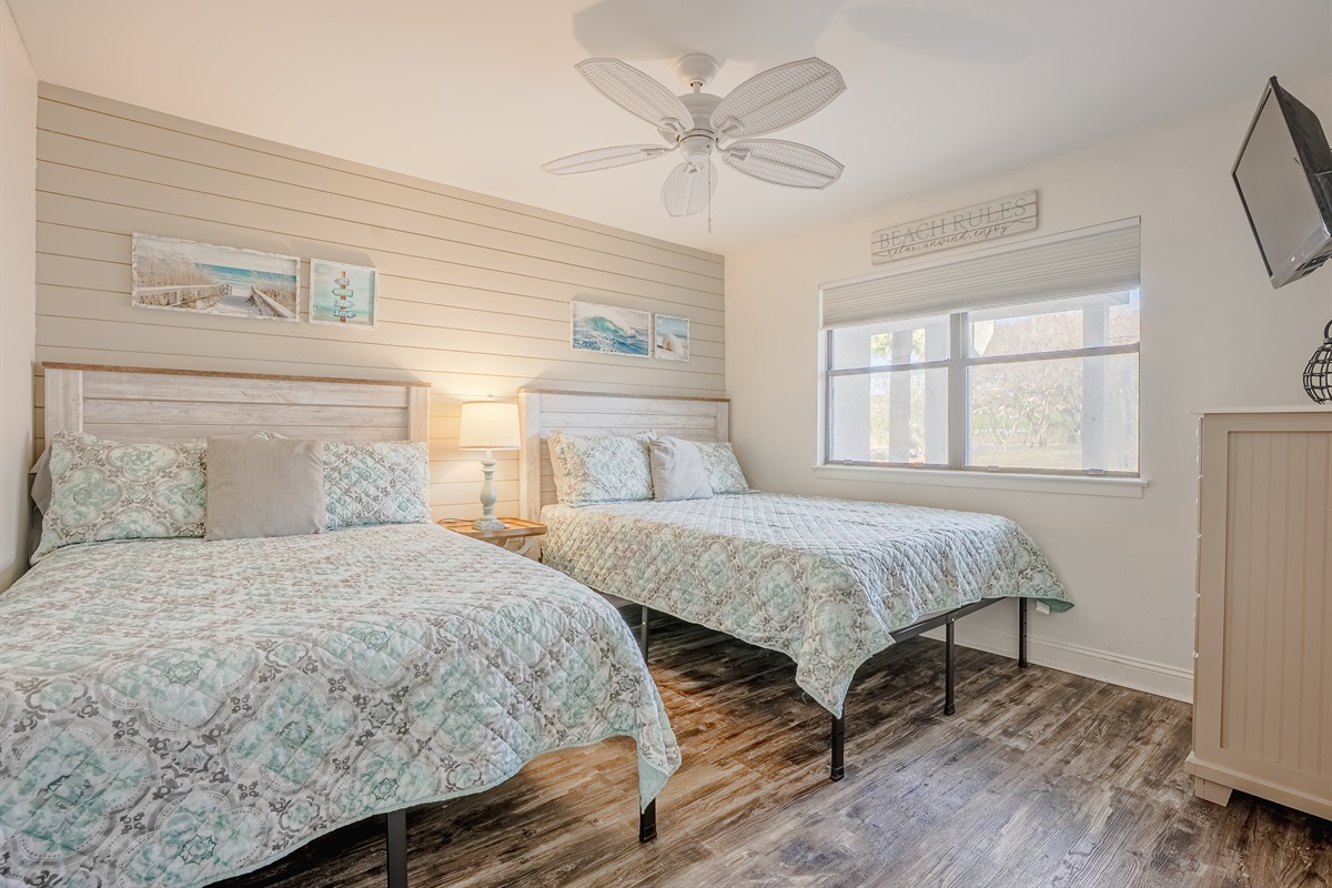 Guest bedroom with one full, one queen, ceiling fan, & smart TV