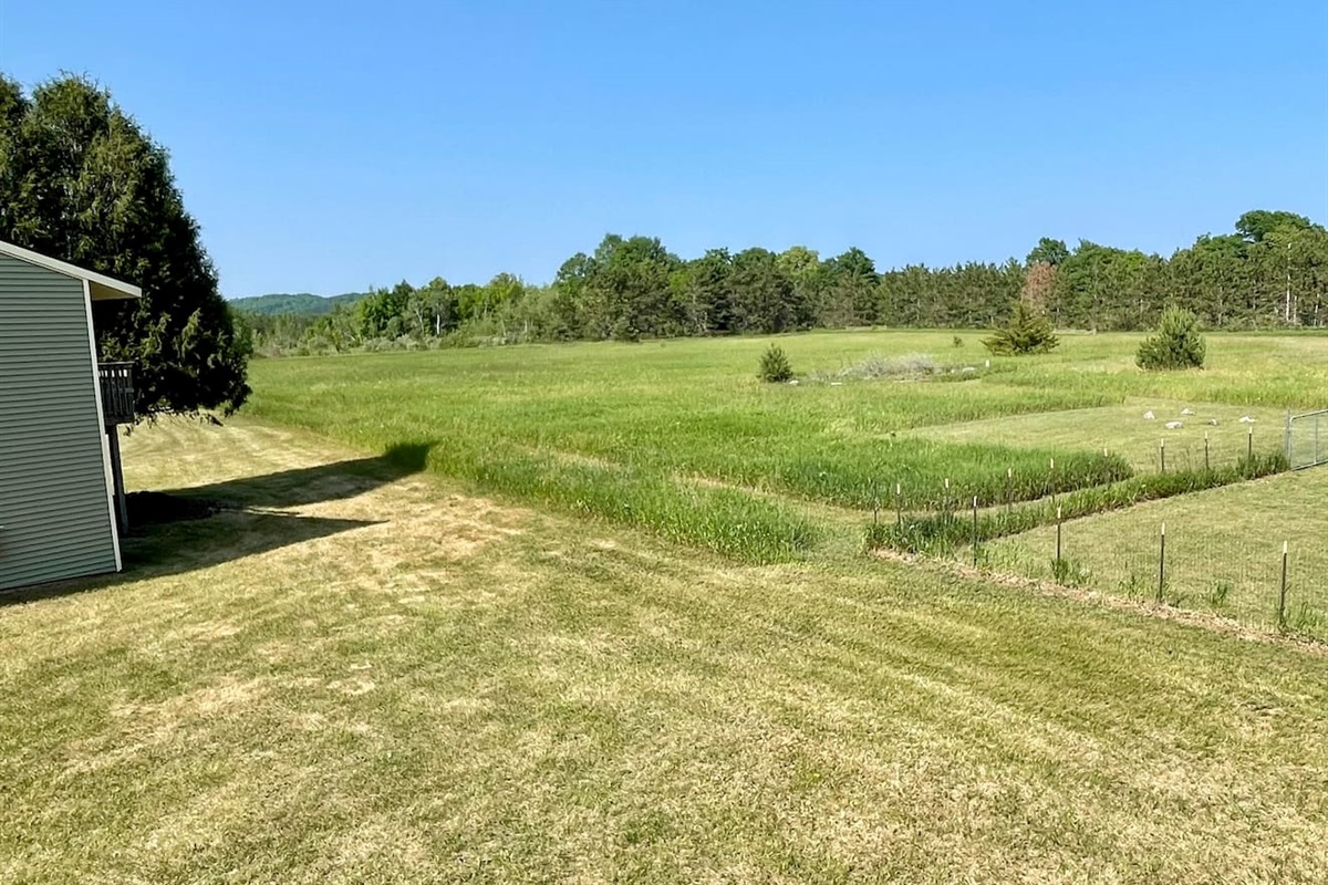 Breathe in the fresh air and take in stunning views of rolling meadows and forested tree lines. This peaceful, private setting offers the perfect escape—ideal for morning walks, birdwatching, or simply enjoying the serenity of nature.