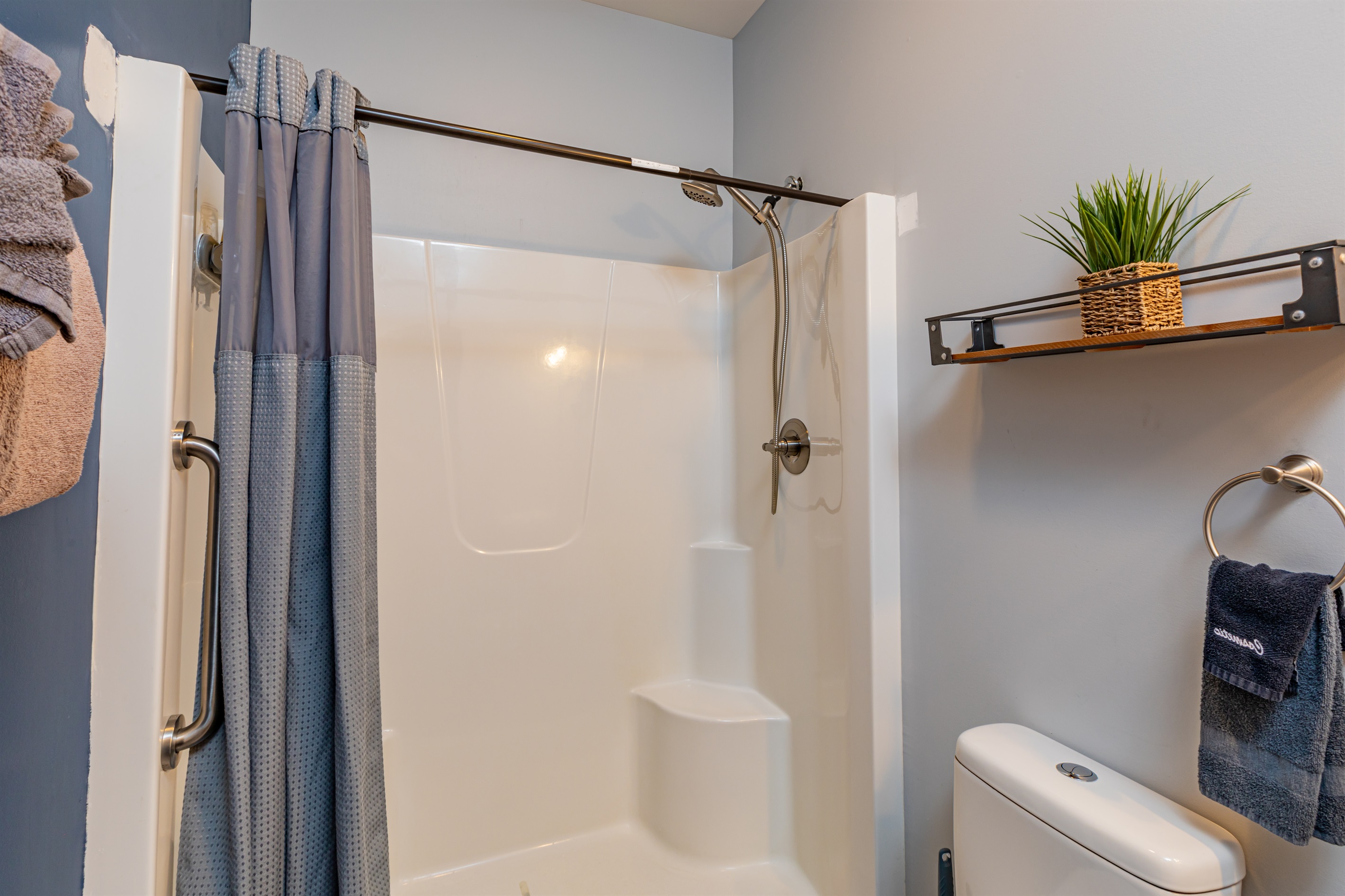 Half bath upstairs in hallway with handrail