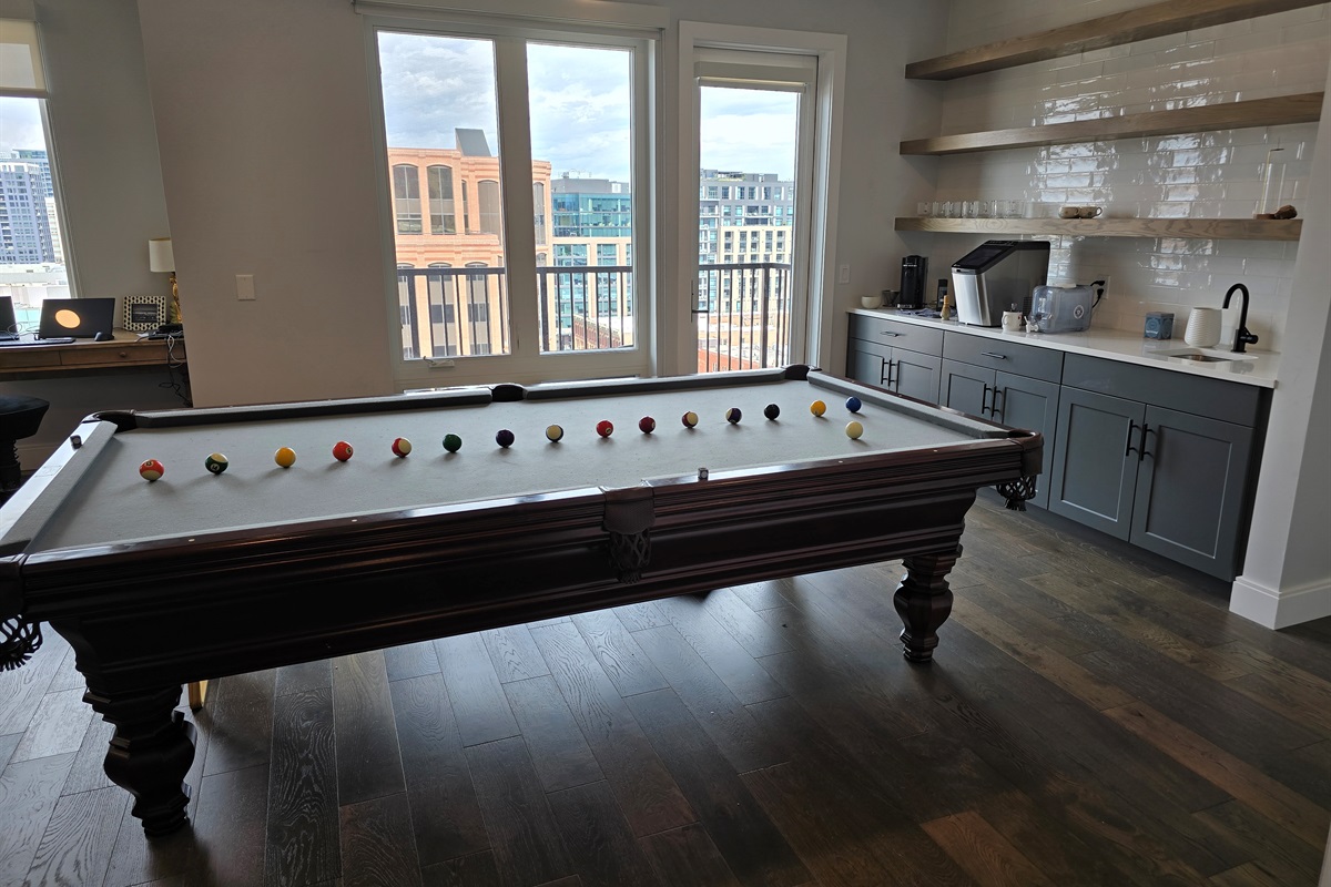 Amazing downtown view while playing pool and bar/sink area close by.