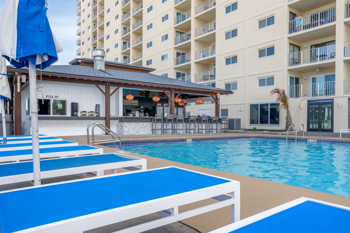 Soak up the sun on a shaded lounger, just steps from the beachfront bar and sparkling poolside bliss.