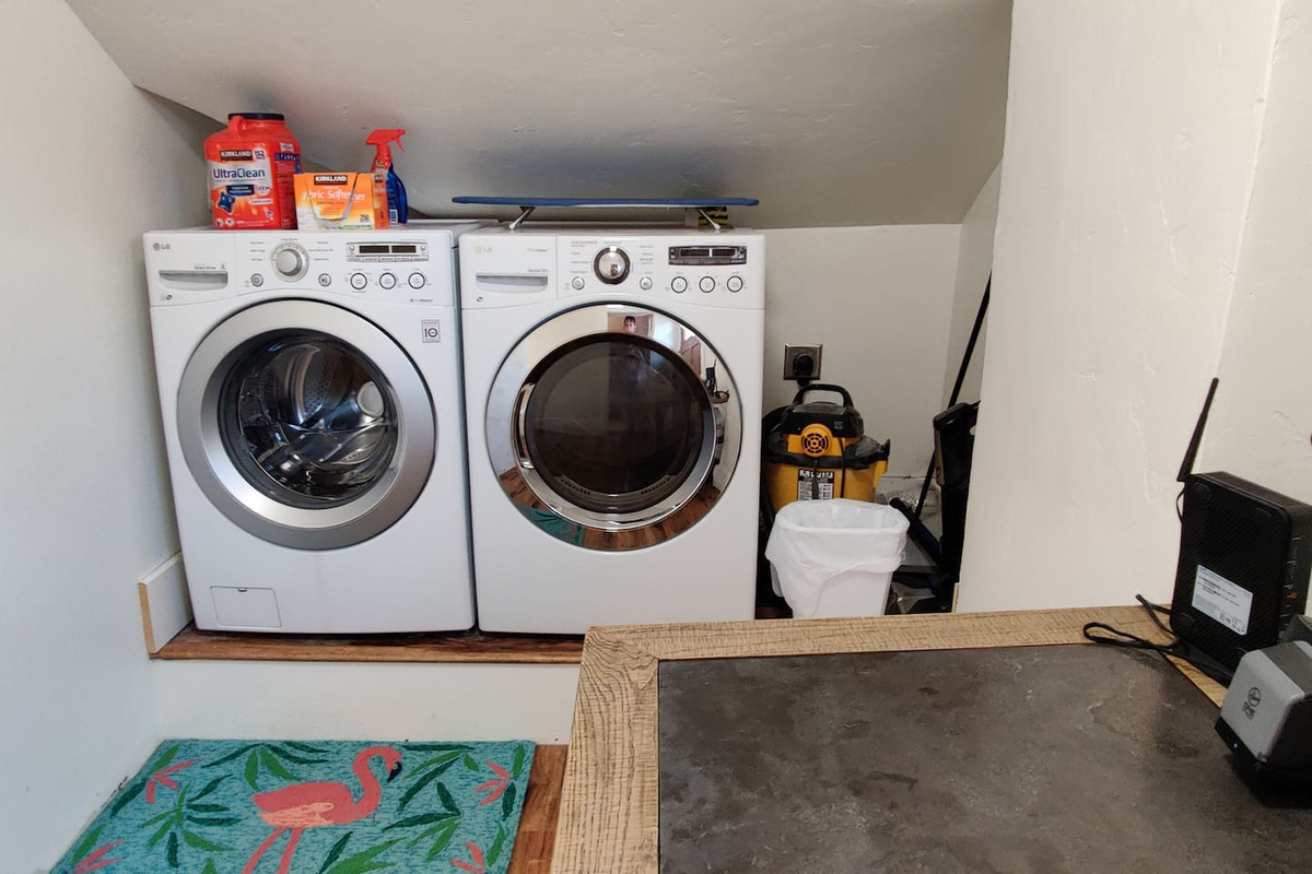 Utility room with new washer and dryer.