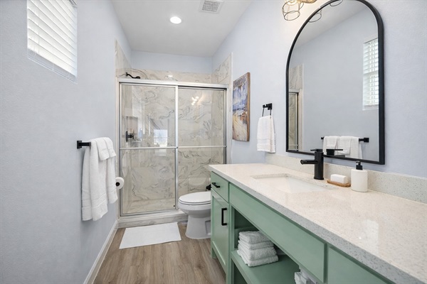 Primary Ensuite (Upstairs level): Sleek walk-in shower and private access from the King master bedroom.