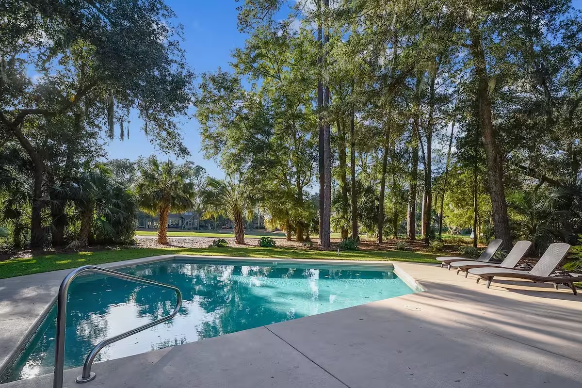 View from deck overlooking pool and 11th green of Heron Pointe