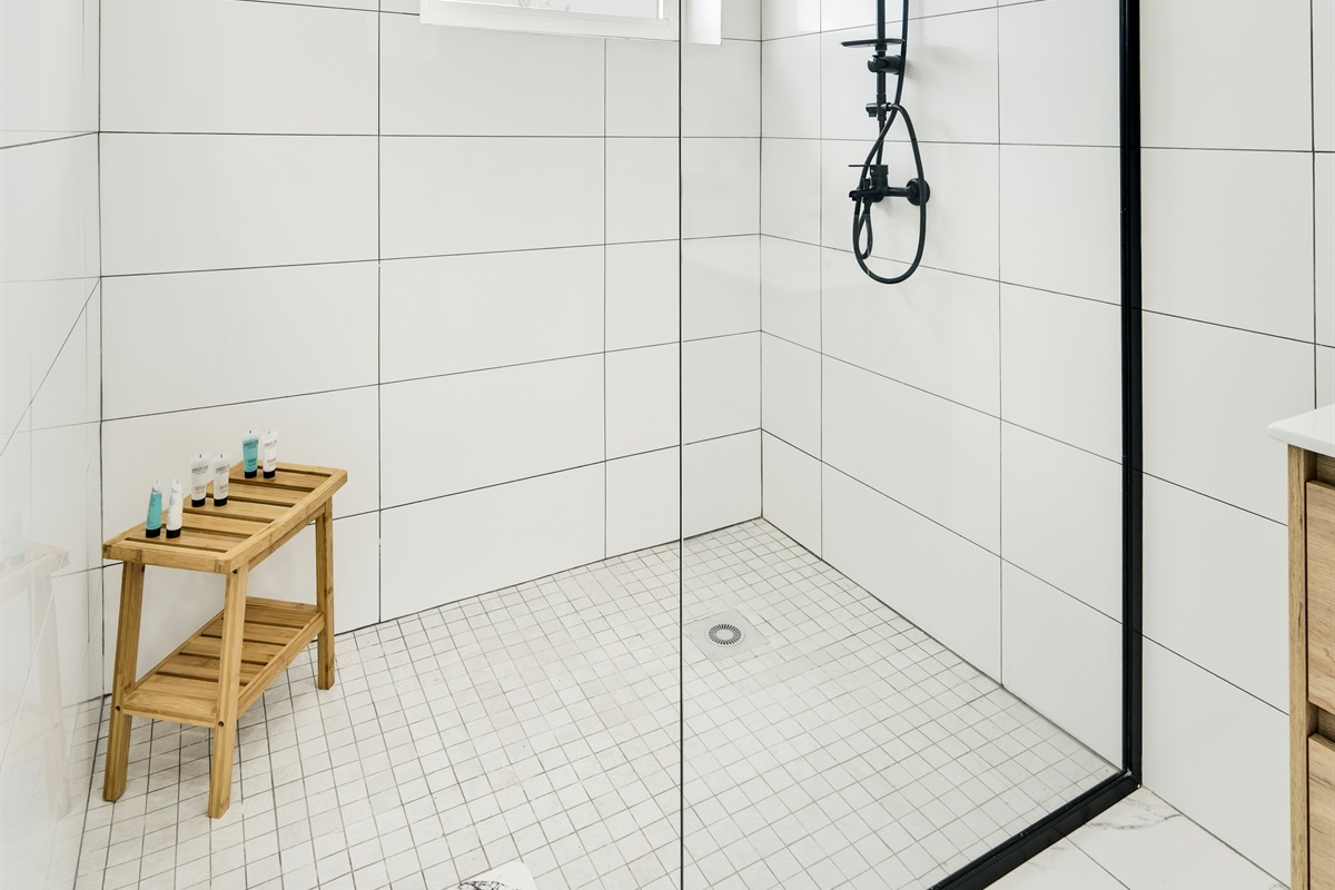 Spacious Walk‑In Shower with Glass Enclosure & Wooden Bench