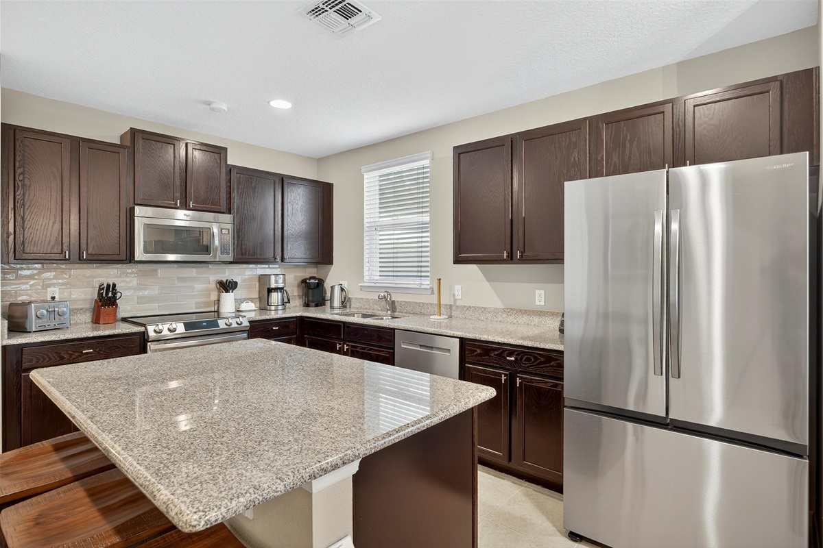 Modern, fully equipped kitchen with stainless steel appliances and plenty of counter space.