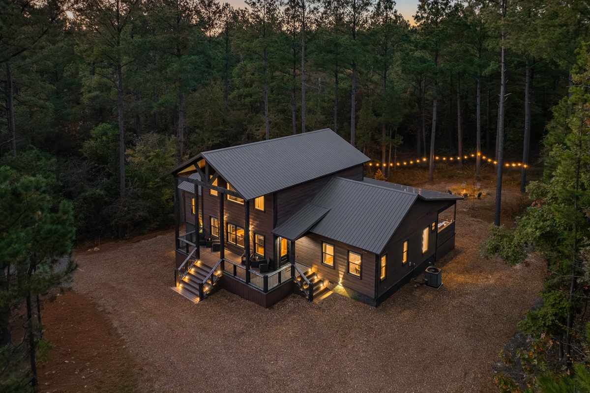 A breathtaking aerial view of Pinewood Lodge tucked into its own private forest clearing. Total seclusion and natural beauty in every direction.