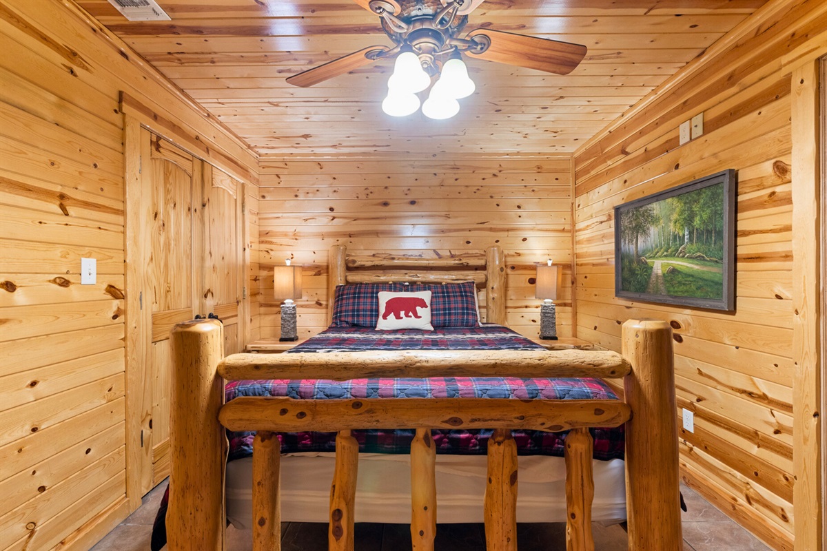 Queen log bed and warm wood interior