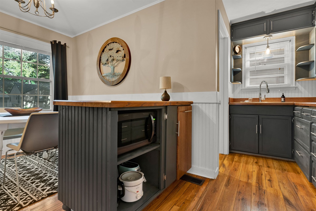 Another view of our kitchen, showcasing where some appliances are conveniently located for easy use during your stay.