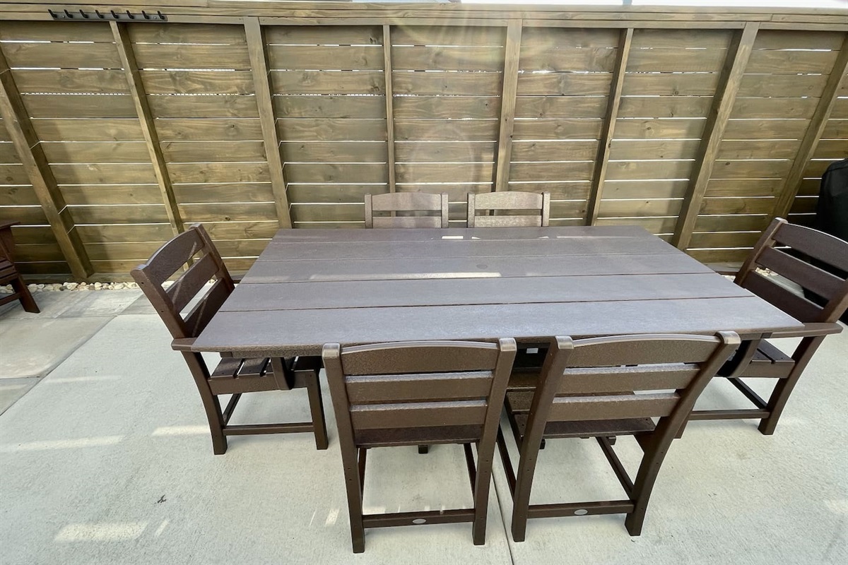 A fenced-in outdoor dining area with plenty of seating. It’s a nice, private spot to enjoy a meal outside.