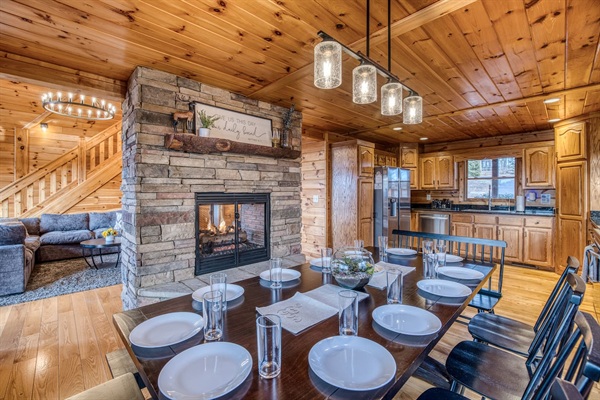 Dining area right off the fully-stocked kitchen that has seating for 12, with double-sided fireplace between dining area and living room.