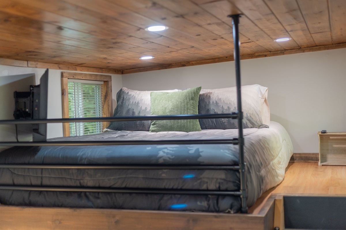 The queen loft features a cozy memory foam mattress for restful mountain nights.