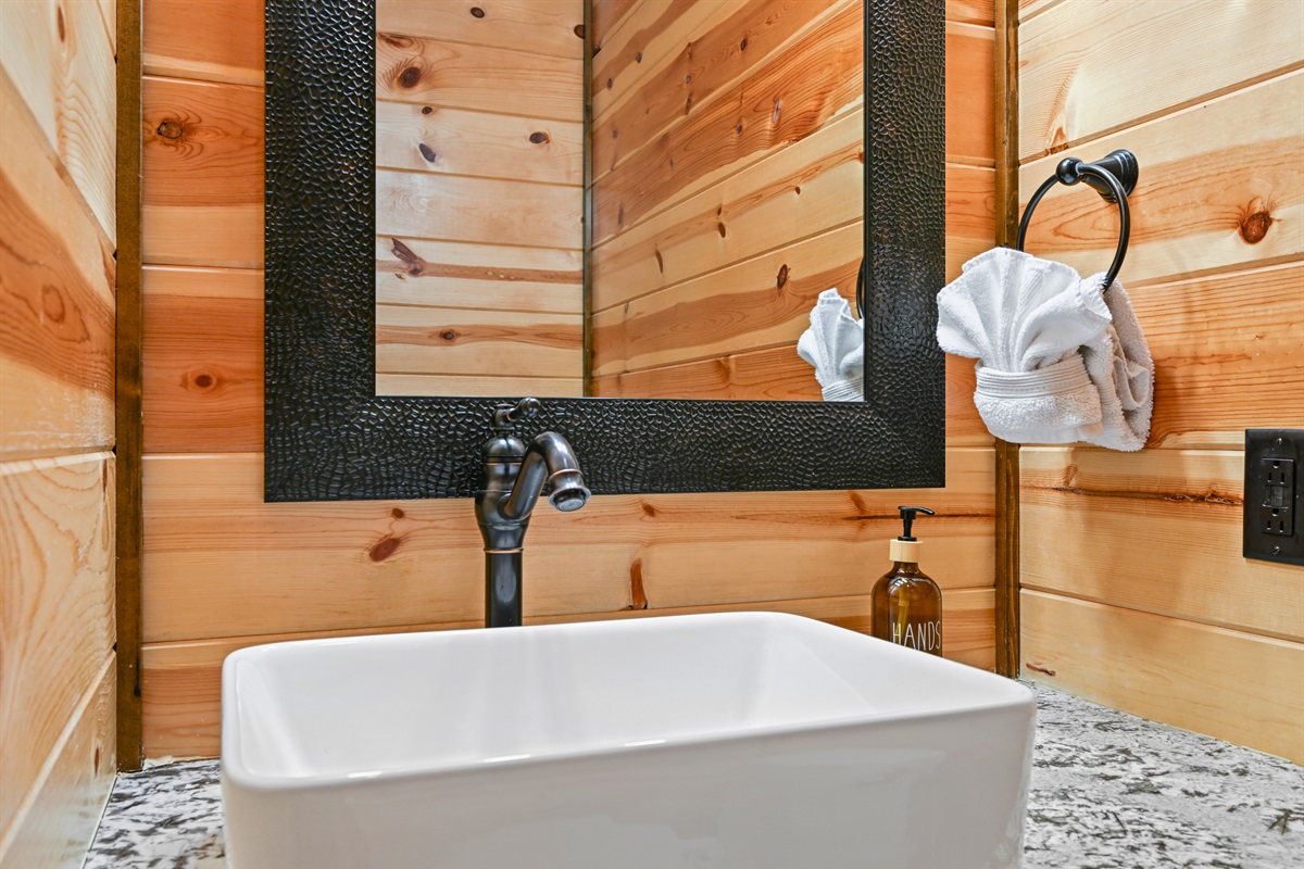 Simple and stylish, this guest bathroom is stocked with essentials and outfitted with elegant natural finishes.