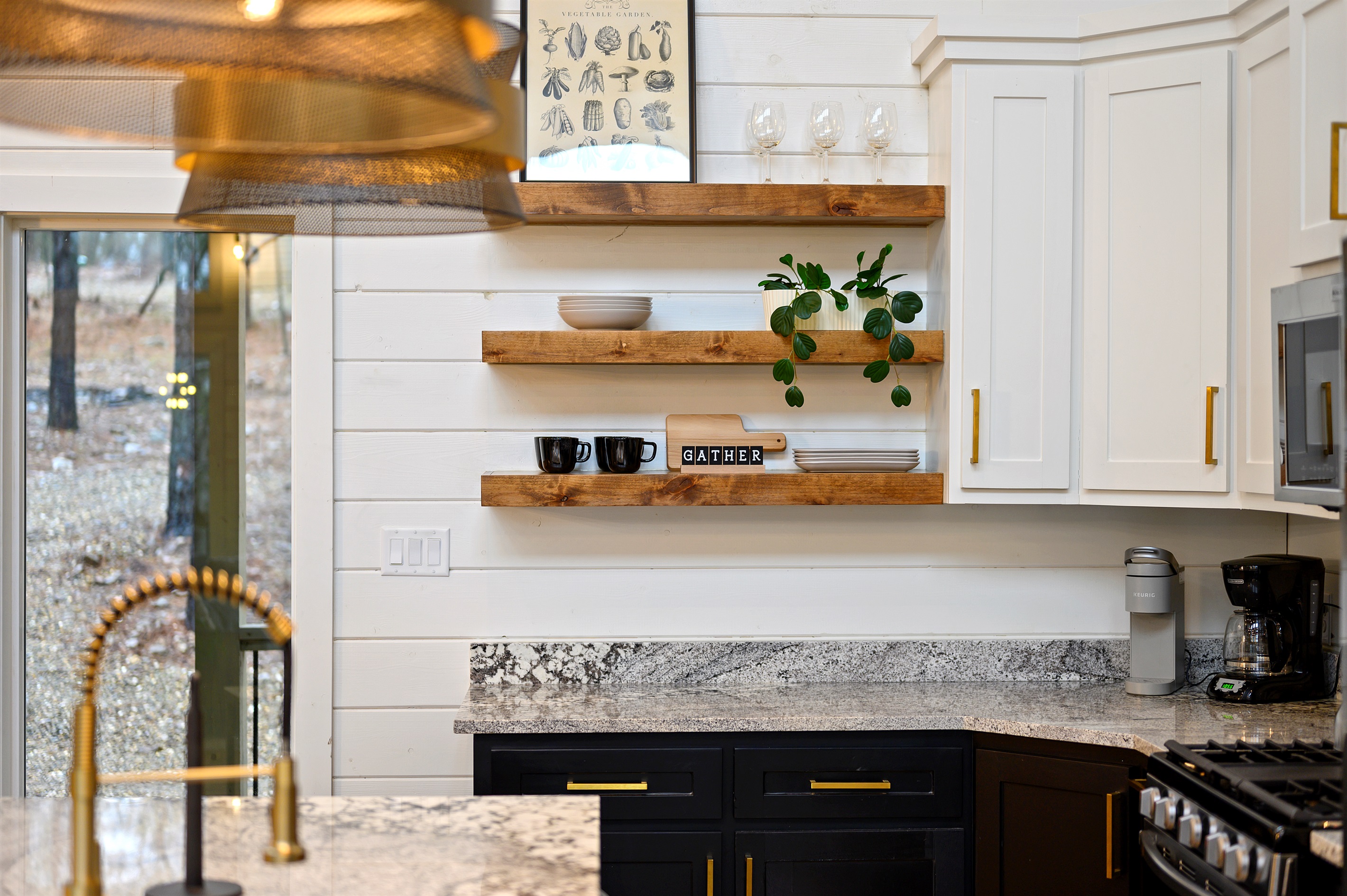 A functional kitchen space with sink, cookware, and dinnerware provided, making it simple to cook, serve, and enjoy meals at the cabin