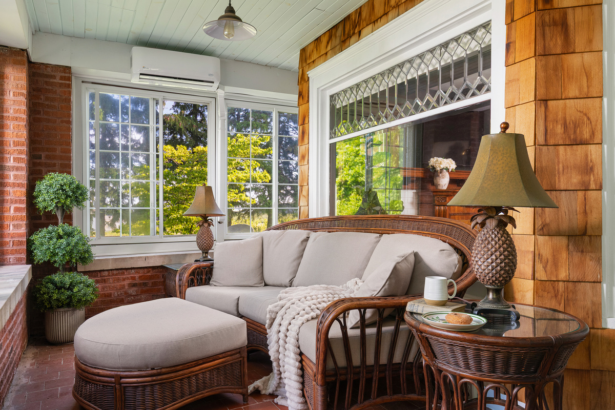 Your favorite seat may be in the sunroom, where oversized windows, cozy seating, and tranquil views create the perfect place to slow down and enjoy every moment. 