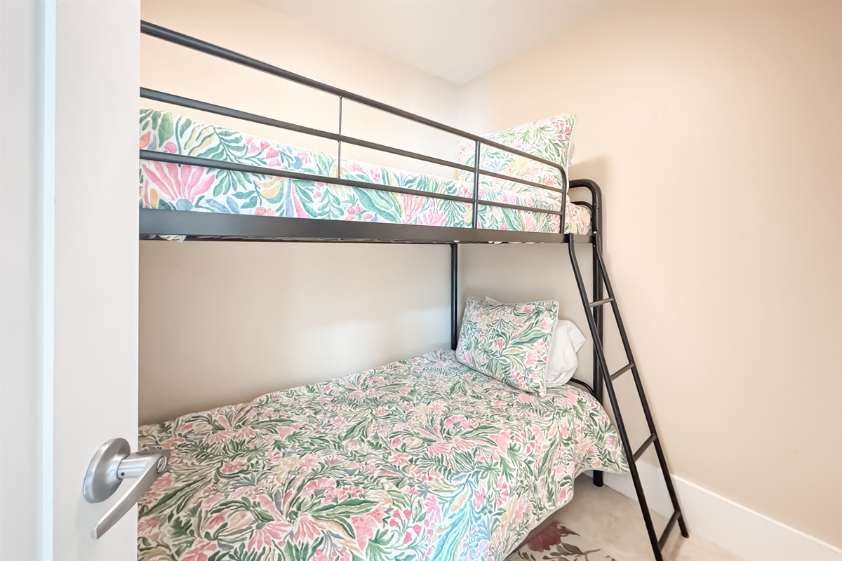 Versatile bunk bed room offering comfortable accommodations for guests or family. This space maximizes functionality and style, providing a cozy and inviting atmosphere.