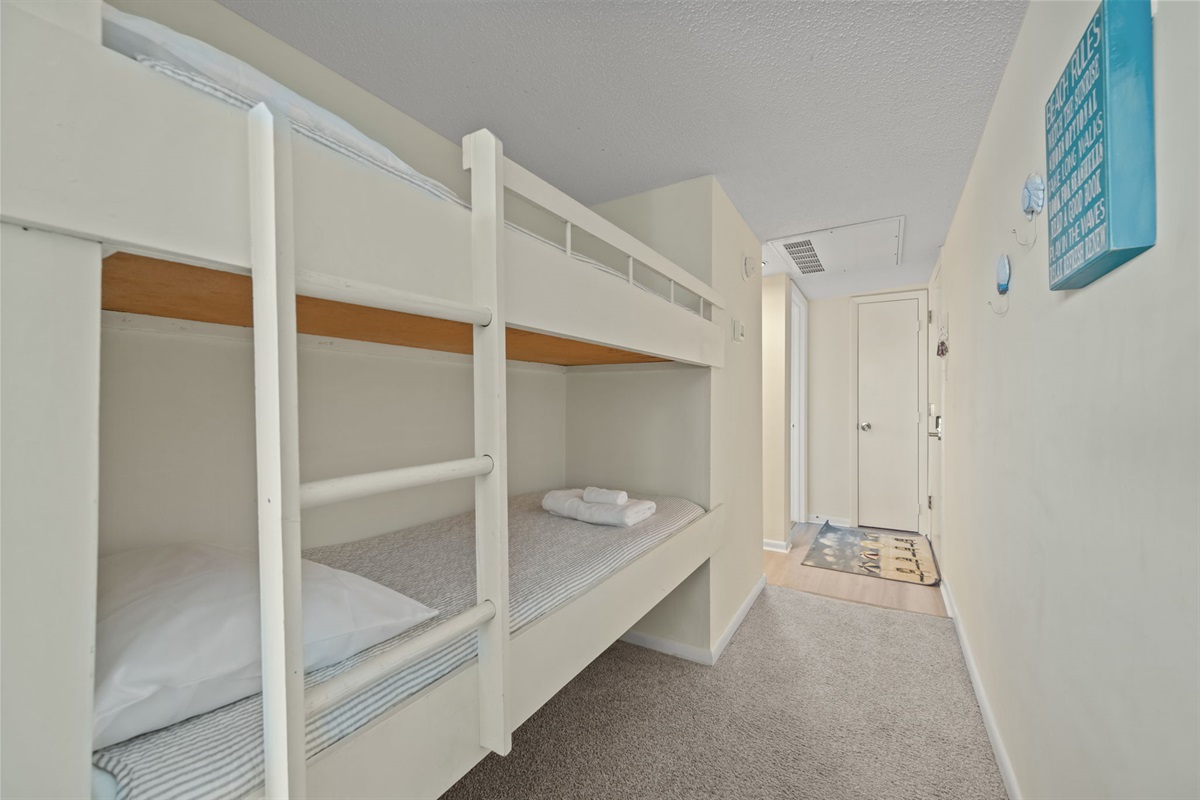 Built-in hallway bunks add smart sleeping space, with easy ladder access and tucked-away design that keeps the living areas open