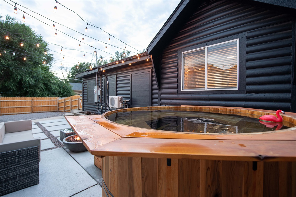 Cedarwood soaking hot tub perspective looking towards the main house and walkway to garage and driveway area where back patio is accessed easiest.