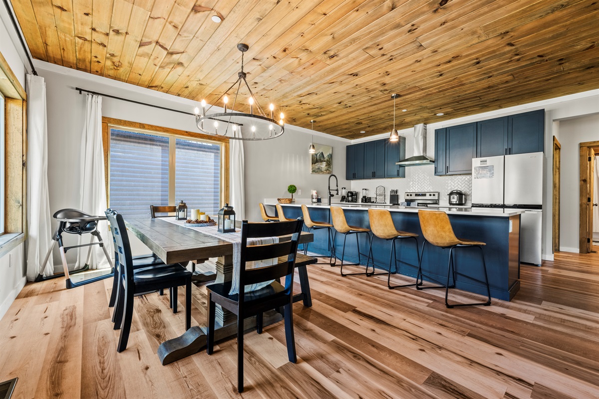 Luxury kitchen area with dining table that seats 10. There is additional seating for 6 at the countertop bar.