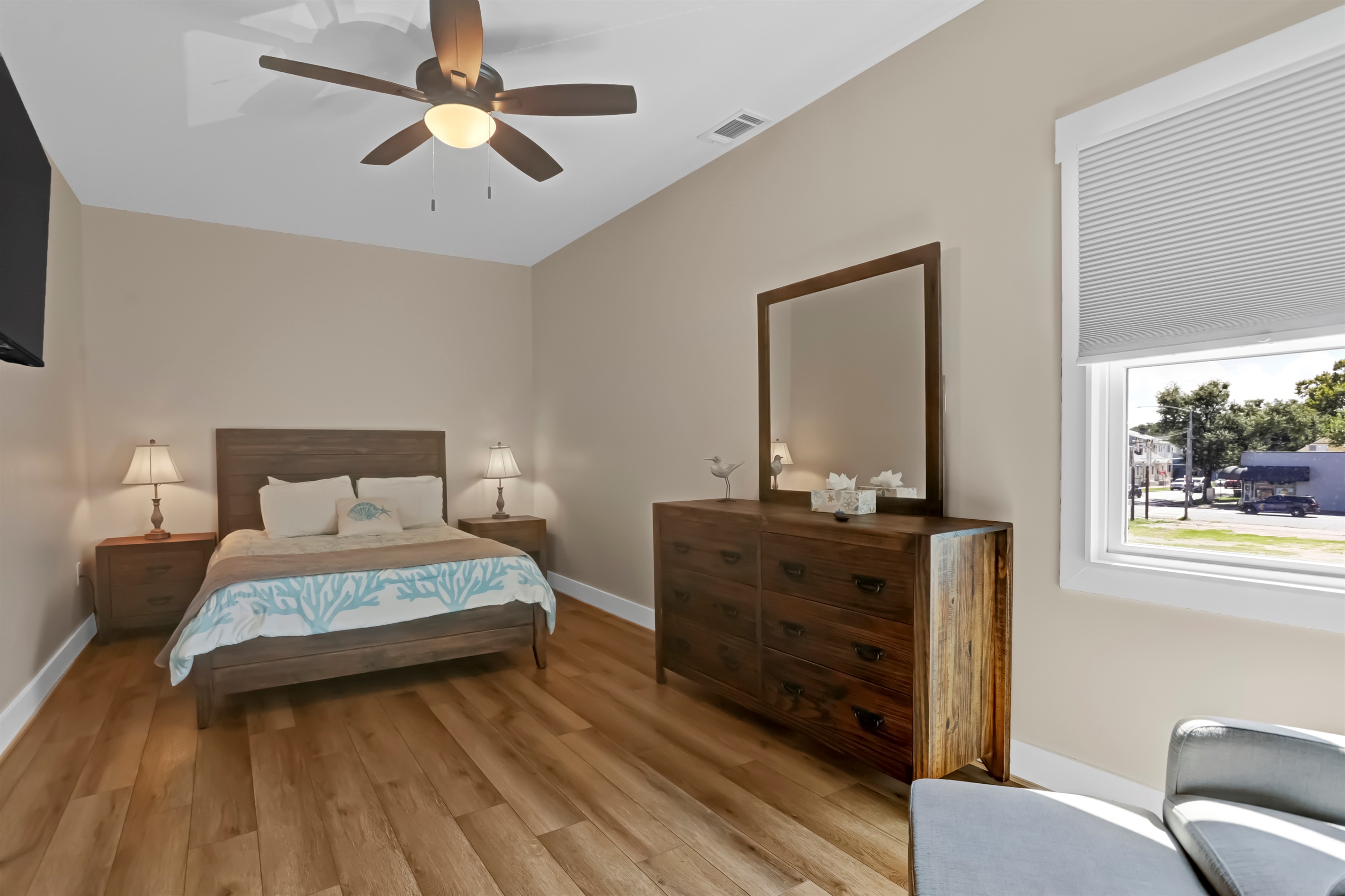 Warm wood accents bring a touch of charm to the primary bedroom.