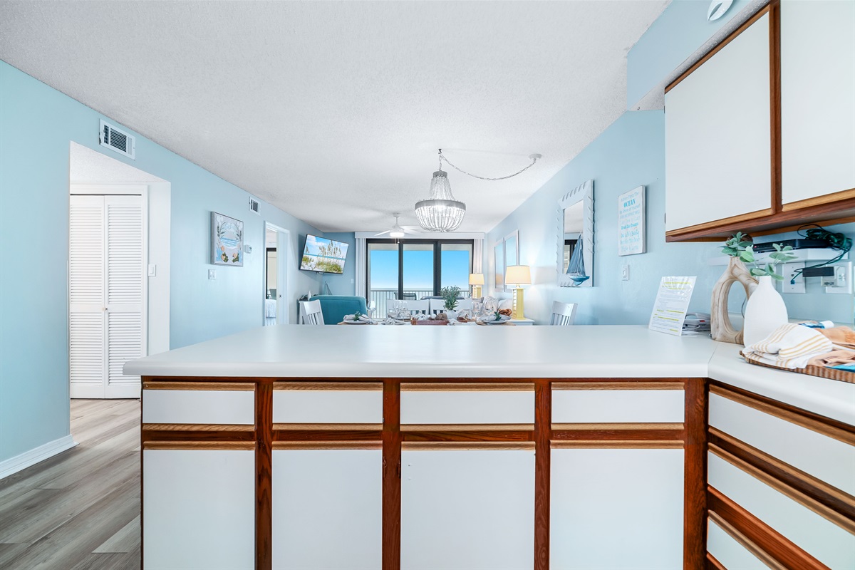 The kitchen island takes center stage, offering ample counter space and casual seating. Perfect for meal prep, entertaining, and everyday living.