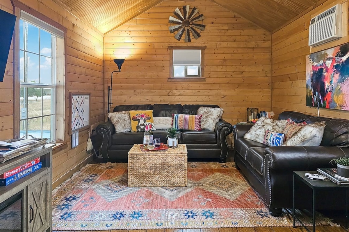 Cozy up in our cabin's living space where rustic charm meets homely comforts for those perfect indoor moments.

