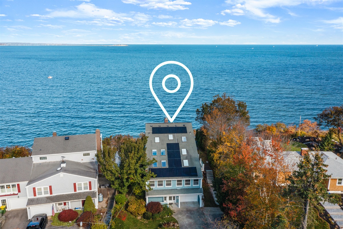 Bird’s-eye view showcasing the house and sparkling coastal waters