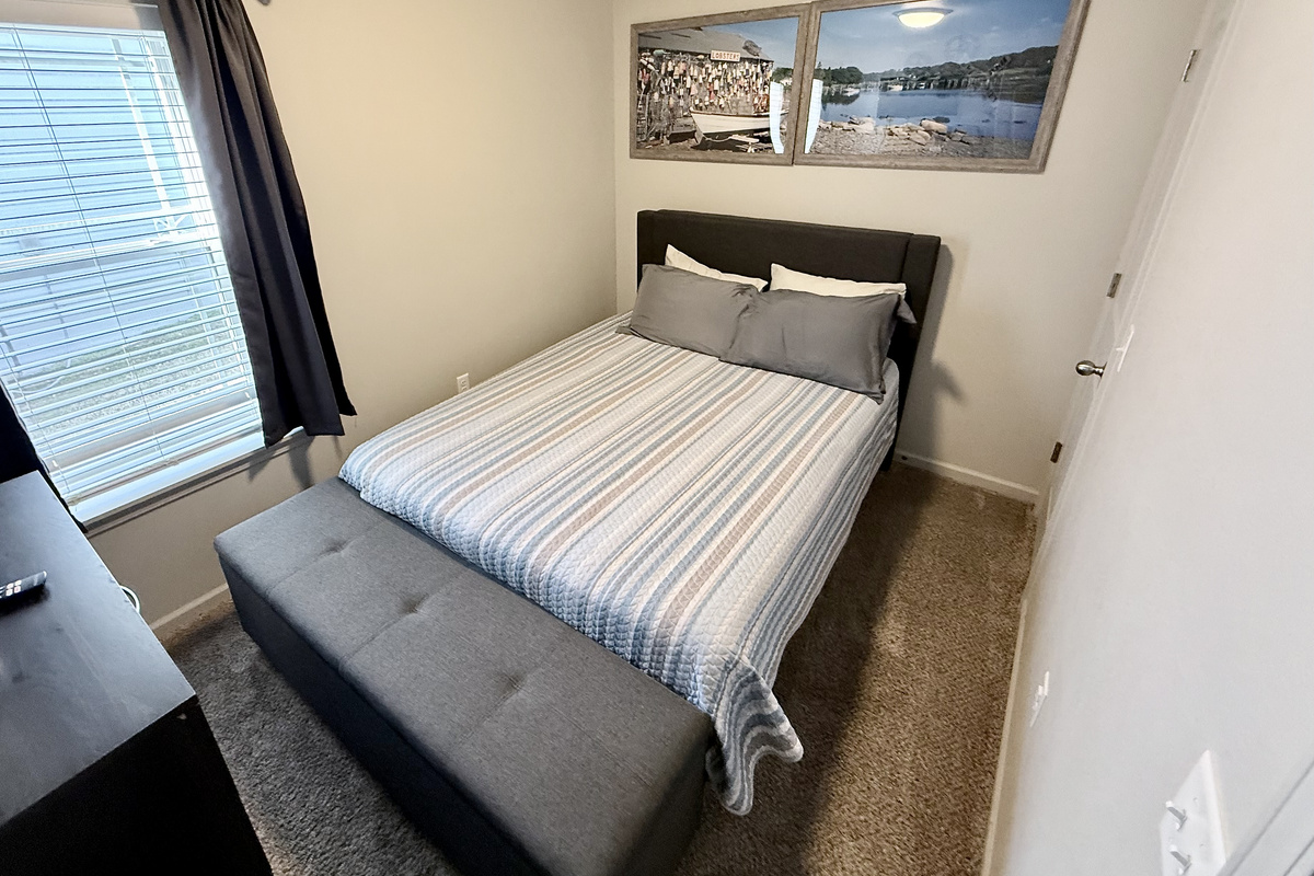 Bedroom 2 with Queen size bed and a place to sit at end of bed