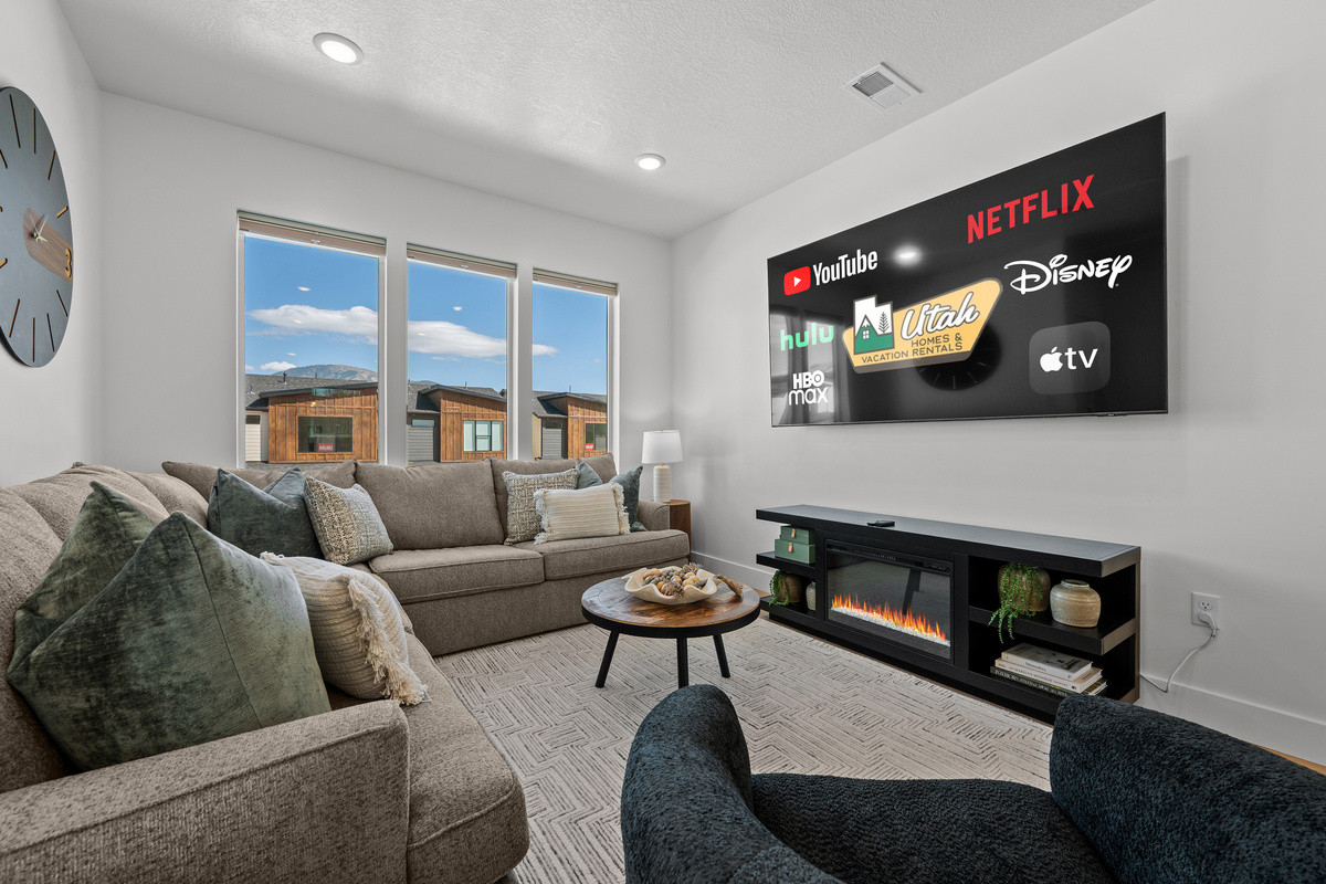 Kick back in the living room with the large TV and cozy fireplace, perfect for winding down after a day outdoors.