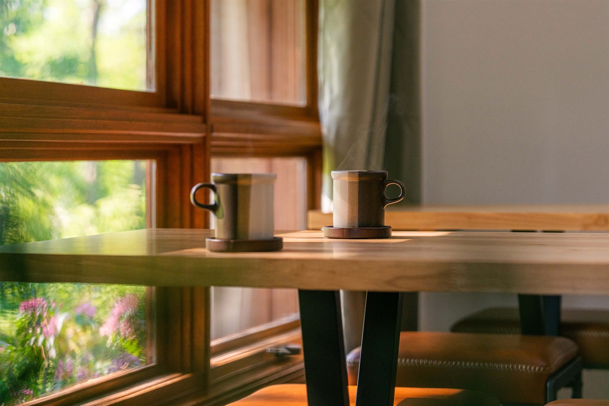 Start your mornings slow with coffee and sunshine streaming through picture windows