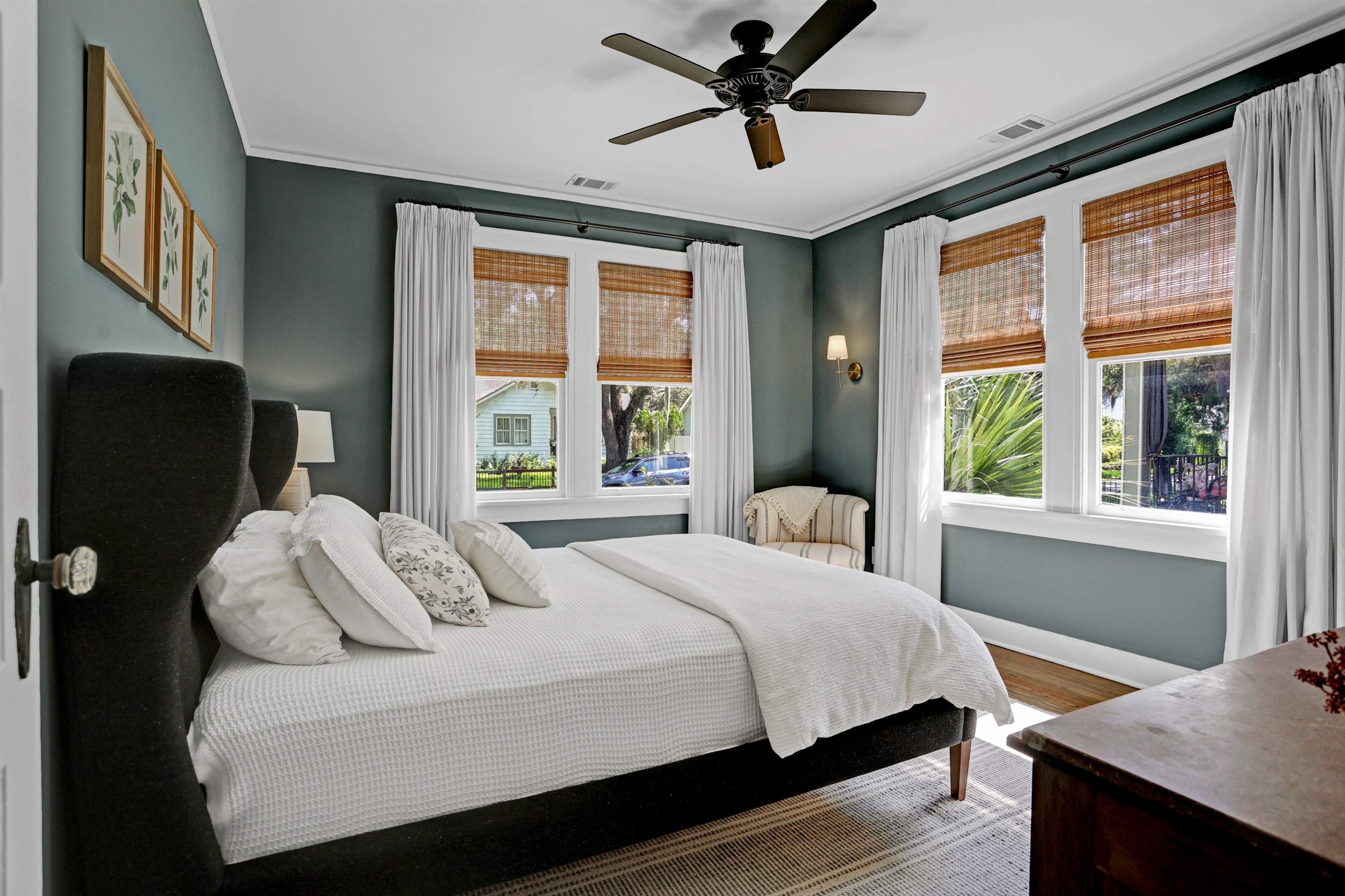 Natural light floods the room, highlighting the serene color palette and cozy textures.