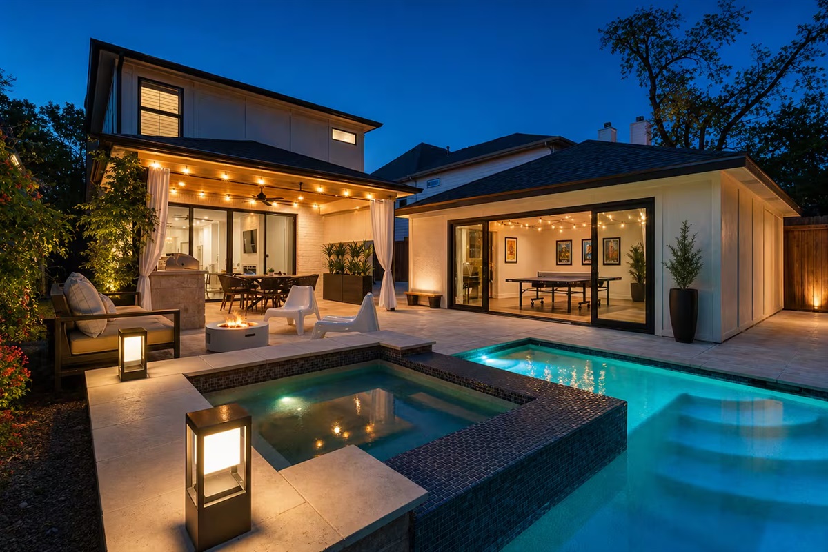 Luxury backyard oasis with glowing pool & lounge areas