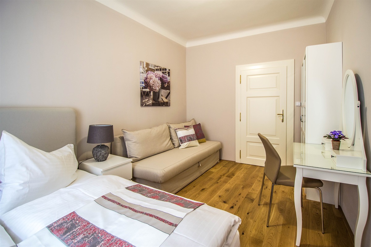 1st bedroom with a huge bed for 2 people, convertible sofa, with could be transformed into the real bed, spacious wardrobe and a dressing table
