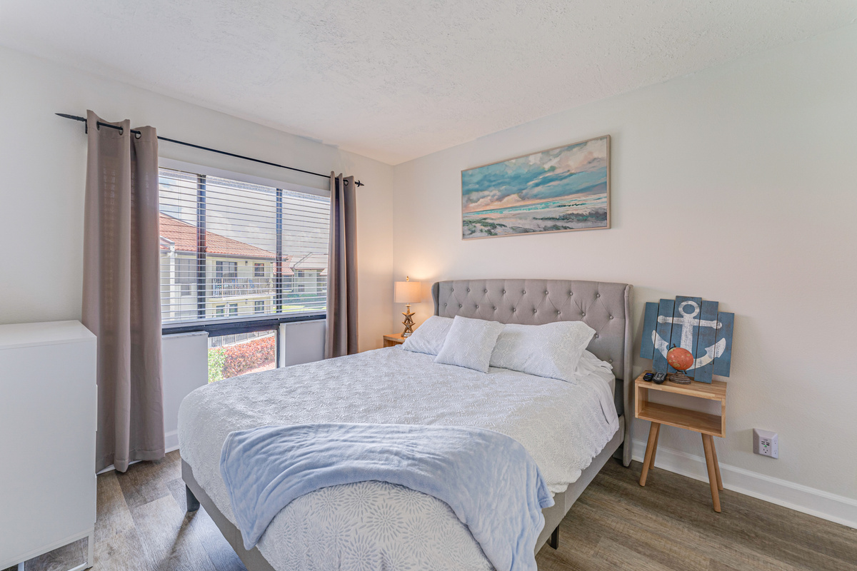 Relax in the comfort of the primary bedroom, featuring a private ensuite bathroom and direct access to the balcony. It's a peaceful retreat to recharge after a day in the sun.
